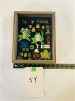 Shadow box full of misc frog patches, pins, ect
