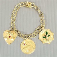14K gold bracelet with 3 - 14K gold charms (some