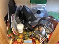 Contents in cabinet, bread pans, cookie sheets,
