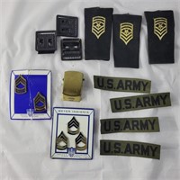 Various US Army patches, belt buckles, and pins