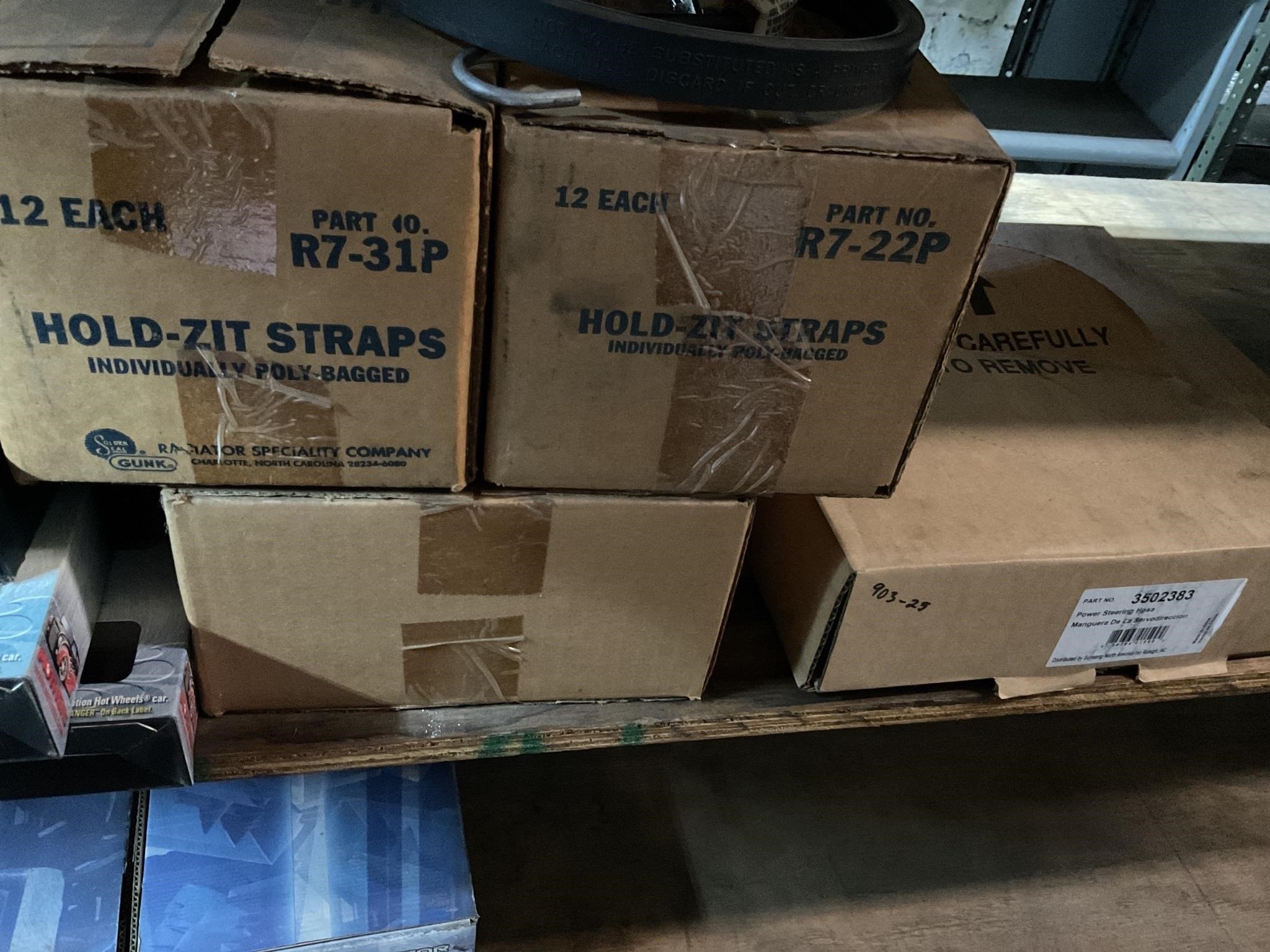 Boxes of rubber, tiedown straps, & steering hose