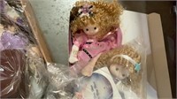 Box lot of dolls. One is a musical motion doll.