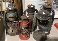 Group of five old kerosene lanterns and various