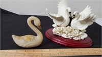 Porcelain and glass swan figurines.
