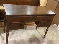 Dark stained wood writing desk with a larger