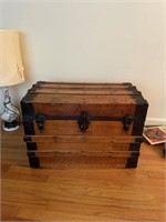 Medium sized wooden trunk with blanket and misce