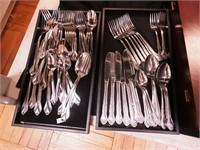 Two sets of stainless steel flatware: one by