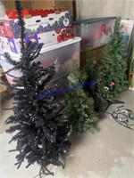 Group of Four Small Pre-lit Christmas Trees
