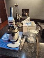 Microscope, beakers, syringe, slides
