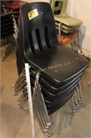 7 stacking chairs, top one has crack