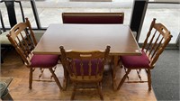 Solid oak table w/ (3) upholstered chairs &