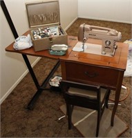 White electric sewing machine in cabinet with