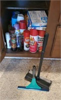 Cupboard of cleaning supplies, squeegees
