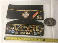 Military caps, belt buckle, and pins.