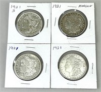 Four 1921 Morgan Silver Dollars.