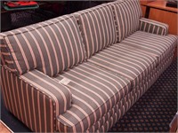 Three-cushion sofa bed with green striped