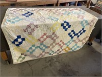 Quilt appears to be both hand and machine sewn