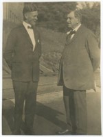 7x9 Two men in suits speaking