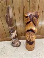 Two carved wood statues about 24 inches tall