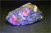 Natural Ruby Crystal Formation In Matrix Under UV