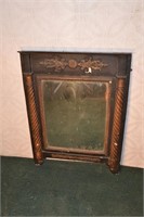 Wall mirror with gilt columns and foliate decorati