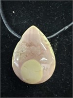 Teardrop shaped Australian rhodonite cabochon on