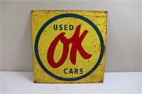 Yellow metal OK Used Cars sign