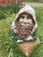 Concrete gnome statue, weathered with few cracks