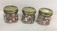 3 mini glass jars full of pink and clear glass