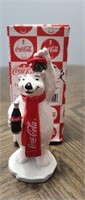 1997 Coca-Cola bear figurine holding a mistletoe