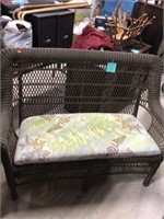 Brown resin wicker love seat and cushion