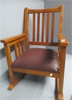 Antique childs wood rocker with leather seat.