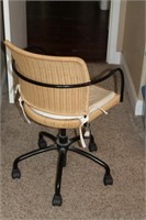 Wheeled wicker desk chair with cushion