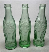Three Glass Coca Cola Bottles