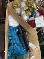 Box of Christmas ornaments and a blue Christmas