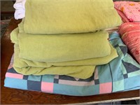 stack of bedspreads