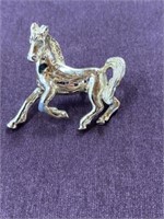 Gold tone horse brooch