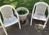 2 plastic chairs and planter pot