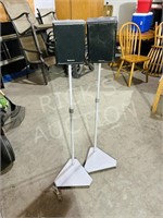 set of small speakers on adjustable stand