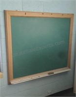 Framed chalk board mounted on wall. 60×48. Buyer