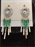 Beaded dangle earrings. Green and silver colors.