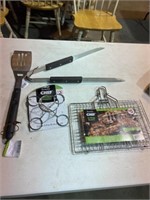 Grilling basket, tongs, spatula and chicken