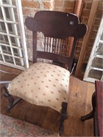 Antique rocking chair with padded seat