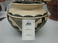 Black and cream colored Indian pottery bowl.
