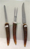 Vintage carving set with antler like handles.