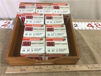 9 empty 28 gauge boxes in a wooden box