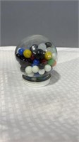 Round jar of game marbles.