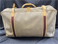 Vintage designer-style suitcase marked Gucci