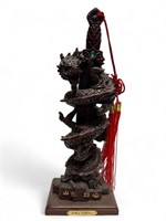 Tall red resin Chinese dragon with sword sculpture