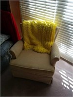 Cloth swivel  rocking chair with yellow Afghan